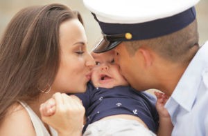 military spouses kissing their baby